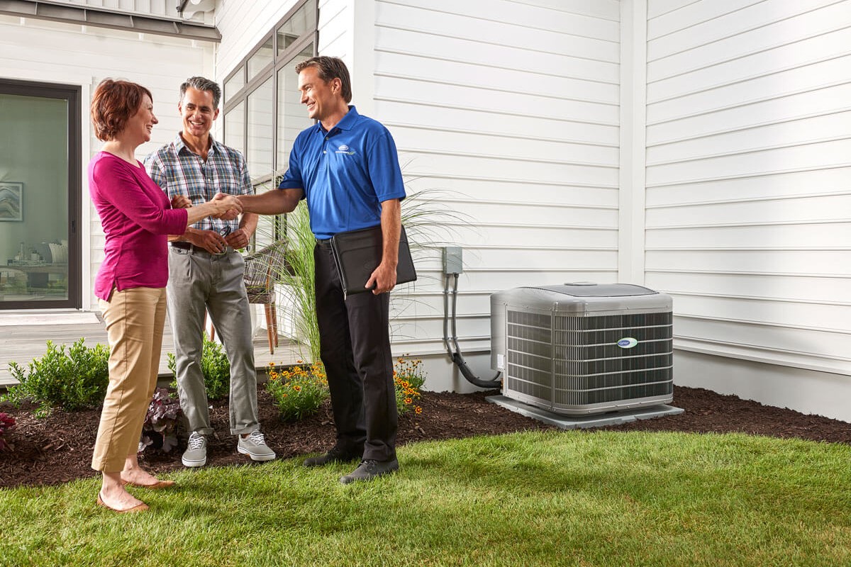 Happy Customers shaking hands with technician after installation of Carrier air conditioning unit- Lincoln, IL