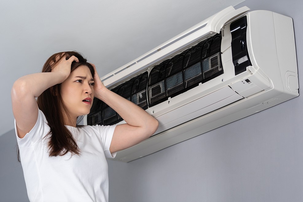 stressed woman has problem with the air conditioner at home - in need of emergency services - Lincoln, IL