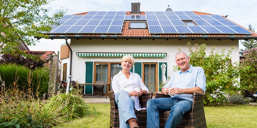 Elderly couple enjoying benefits of savings from using solar energy - Solar panels - Lincoln, IL